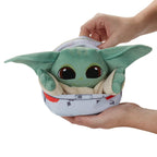 Grogu de peluche en el hover-pram sostenido en la mano