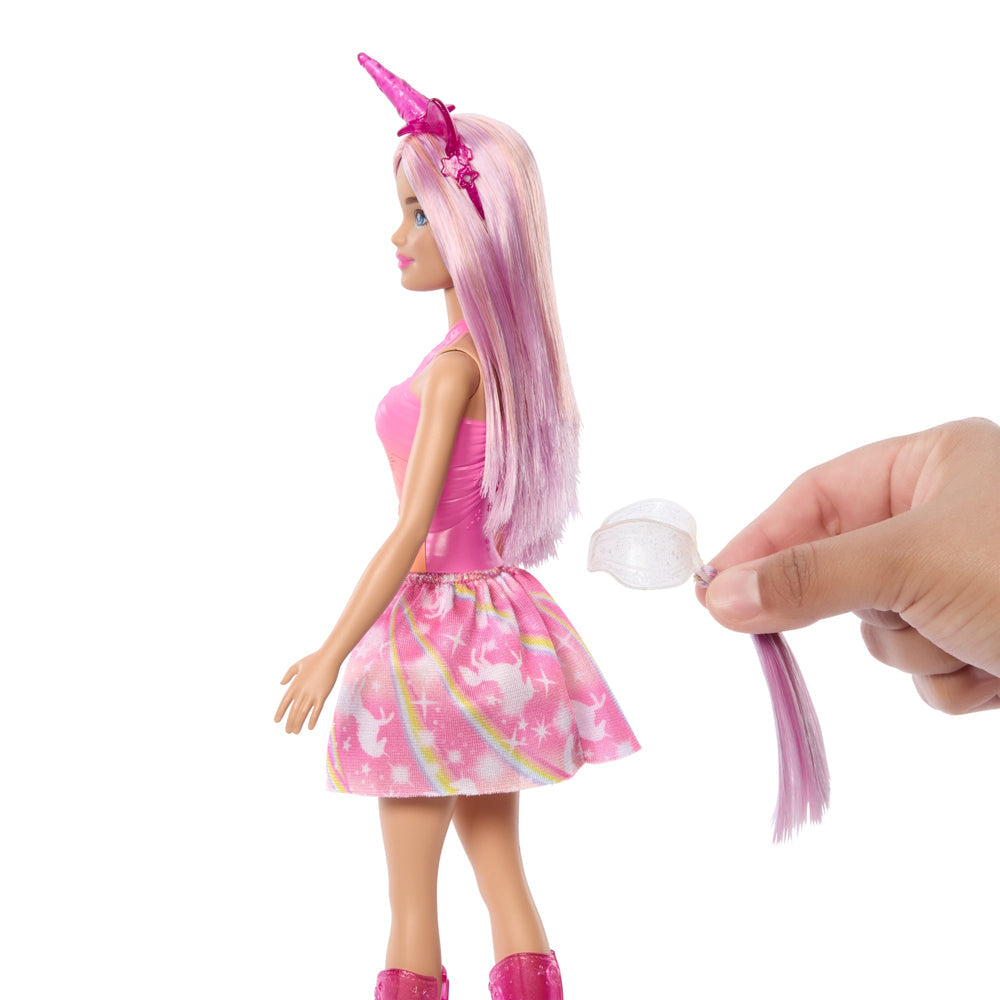 Barbie Unicornio de espalda con la cola removible en la mano