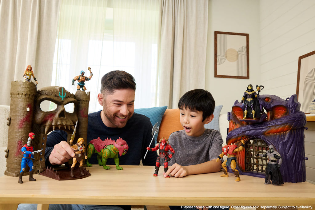 Padre e hijo jugando con el set de Masters of the Universe y sus figuras