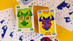 Cartas de ¡Toma 6! con los números 90 y 55 sobre fondo amarillo